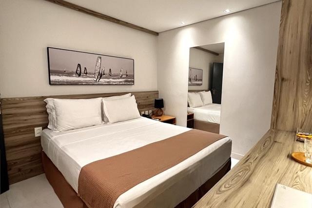 Guest room at Pauli Boutique Hotel with a king bed and windsurfing artwork